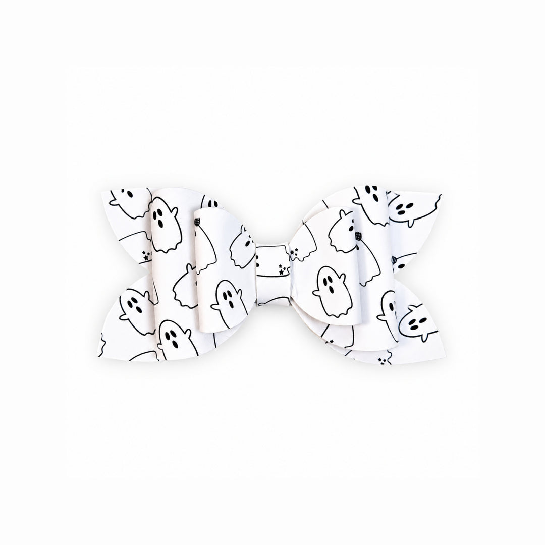 A white faux leather hair bow with a black outline print of cute cartoon ghosts, shown against a plain white background.